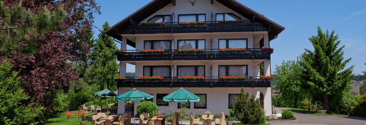 Haus mit Blick auf Gartenterrasse im Sommer - Hotel Konradshof